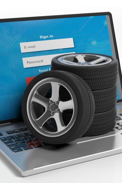 Car wheels on a laptop on white background. 3d illustration