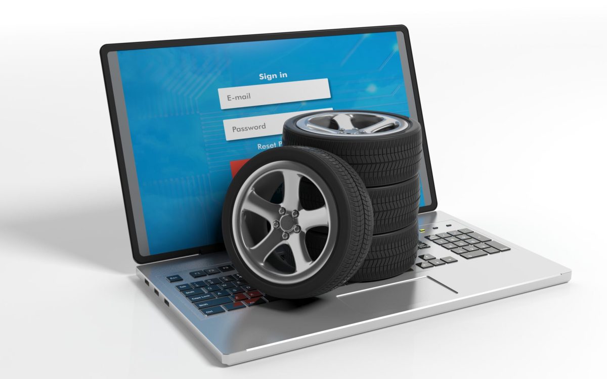 Car wheels on a laptop on white background. 3d illustration